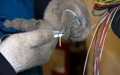 man cutting wires with gloves on