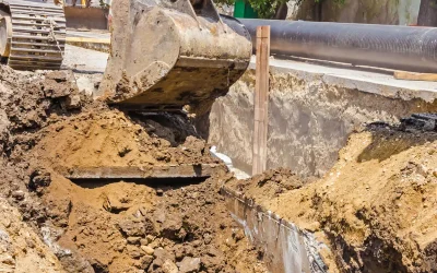 Excavator digging up side of the road
